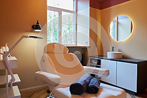 Interior of the cosmetology office with a full-electric beauty bed in a salon