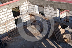 interior of a country house under construction. Site on which the walls are built of gas concrete blocks with wooden formwork