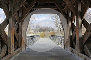Interior of covered bridge with opening at the end.