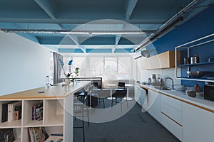 Interior of cozy light boardroom with table, modern stylish chairs and desktop computer, all ready for corporate meeting