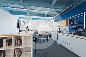 Interior of cozy light boardroom with table, modern stylish chairs and desktop computer, all ready for corporate meeting