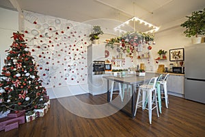 Interior of a cozy modern spacious kitchen for a large family, decorated for the New Year celebration