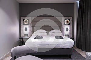 Interior of cozy modern style illuminated bedroom in luxurious resort