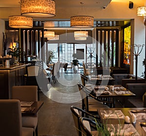 Interior of cozy restaurant. Contemporary design in loft style, modern dining place and bar counter