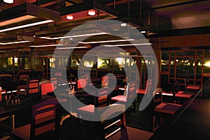 Interior of cozy restaurant at night. Contemporary design style, modern dining place and bar counter. Design and