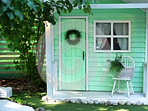 Interior Cozy veranda house  with chair and basket flowers. Decor outdoor of summer yard. Facade House decorated for autumn holida