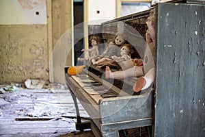 Interior decoration of abandoned private houses with piano and dolls in the exclusion zone of Belarus.