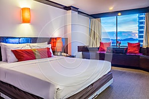 Interior decoration of contemporary bedroom with resting area and sea view