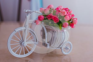 Interior decoration of the registry office, small decorative roses in a bicycle basket