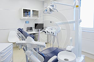 An interior of a dental office with white and blue furniture. DentistÃ¢â¬â¢s office photo