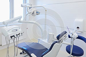 An interior of a dental office with white and blue furniture. DentistÃ¢â¬â¢s office photo