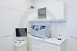 An interior of a dental office with white and blue furniture. DentistÃ¢â¬â¢s office photo