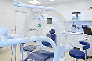 An interior of a dental office with white and blue furniture. DentistÃ¢â¬â¢s office photo