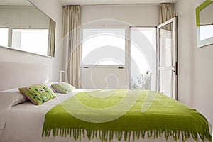 Interior design in bedroom of pool villa with cozy king bed. Bedroom with green and white colors