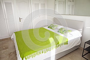 Interior design in bedroom of pool villa with cozy king bed. Bedroom with green and white colors