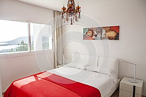 Interior design in bedroom of pool villa with cozy king bed. Bedroom with red and white colors