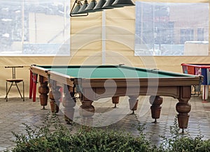 Interior design of a billiard table in the courtyard under a canopy