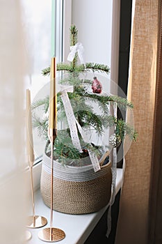 Interior design with christmas tree and candles. Home decor. New Year lace decorations for the Christmas tree in eco