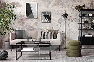 Interior design of concrete living room with mock up poster frame, gray sofa, pillows, simple coffee table, vase with dried