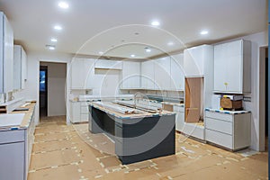 Interior design construction of a kitchen with cabinet maker installing custom