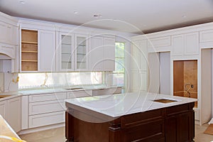 Interior design construction of a kitchen with cabinet maker installing custom