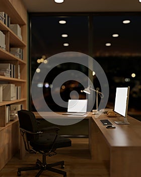 The interior design of a contemporary office at night features a laptop and a PC computer on a table