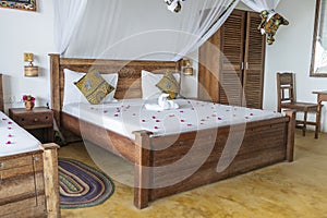 Interior design decor furnishing of luxury show home holiday villa bedroom with four poster bed. Interior design of the tropical