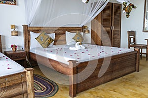 Interior design decor furnishing of luxury show home holiday villa bedroom with four poster bed. Interior design of the tropical