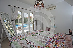 Interior design of bedroom in villa with garden swimming pool vi