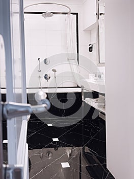 Interior design and decoration materials, luxury black marble tiled bathroom in five stars hotel room