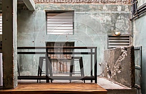 Interior design and decoration with table and two chairs at the background is the old concrete wall