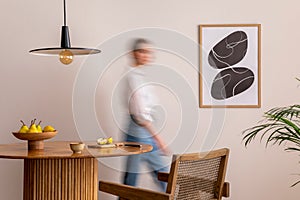 Interior design of domestic dining room space with two mock up poster frames, round table, chair, pedant lamp, decoration and