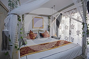 Interior design of double bedroom in house with four poster bed