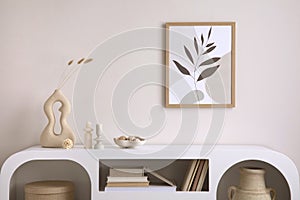 Interior design of harmonized living room with mock up poster frame, white commode, vase with leafs, decoration and personal