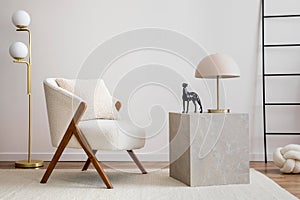 Interior design of harmonized living room with white armchair, coffee table, consola, ladder and personal accessories. Home decor.