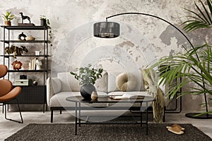 Interior design of indiustral living room interior with gray sofa, black rack, oval coffee table, brown leather armchair, books,