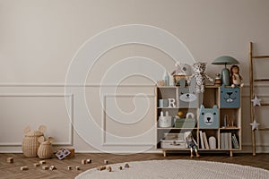 Interior design of kid room interior with copy space, wooden sideboard, round rug, beige wall with stucco, plush toys, ladder,