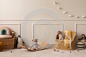 Interior design of kids room interior with wicker basket, yellow plaid, plush animal toys, wooden blockers, white garland, beige