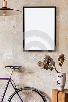 Interior design of living room with black poster mock up frame, bike and elegant personal accessoreis. Grunge wabi sabi wall.