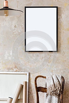 Interior design of living room with black poster mock up frame, chair and elegant personal accessoreis. Grunge wabi sabi wall. photo