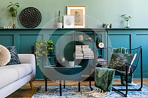 Interior design of living room with green wall, grey sofa and armchair.