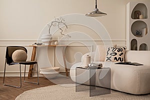 Interior design of living room interior with white modular sofa, chrom bowl, lamp, glass coffee table, wooden bench, stylish rack