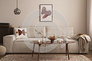 Interior design of living room with mock up poster frame, modern beige sofa, brown braided blanket, wooden coffee table, vase with