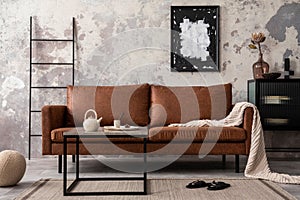 Interior design of loft industrial apartment with mock up poster frame, brown sofa, square coffee table, black commode and stylish