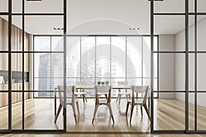 Interior design of modern meeting room with panoramic windows. Contemporary conference board table and chairs. Cityscape view.