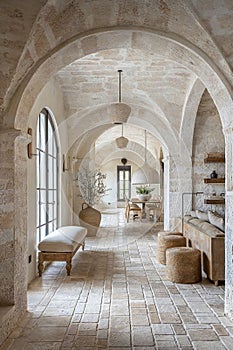 interior design photo of an architectural of a well maintained and luminous Tuscan house in white stone texture and with luxury