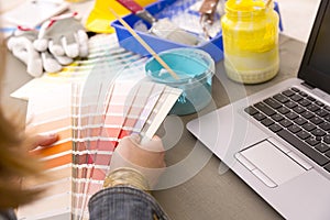 Interior design, renovation and decoration concept - woman working with color samples for selection