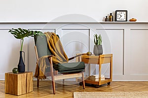 Interior design of stylish living room with vintage green armchair, wooden coffee table, furniture, grey wall, shelf, carpet.