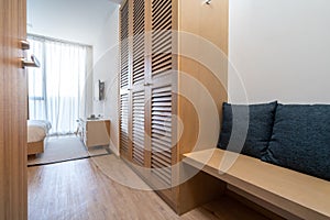Interior design of villa, house, home, condo and apartment feature wooden wardrobe, seating area and blue cushion in bedroom