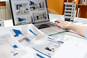 Interior designer working with a kitchen visual renderings in a design bureau